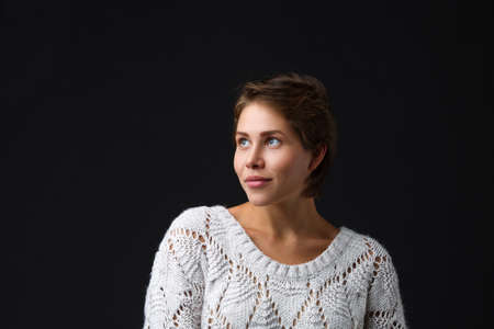 Dark-haired girl with short hair on a black background.
