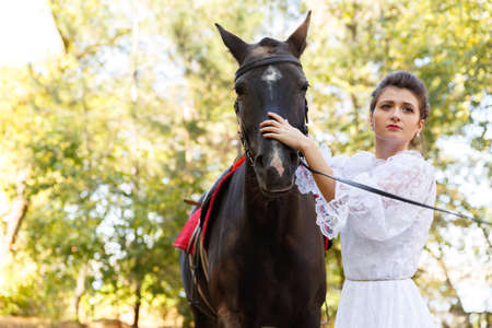 Portrait of a beautiful bride and horse. Close-up.の写真素材