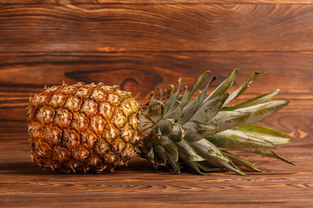 Close-up of pineapple on a wooden brown backgroundの写真素材