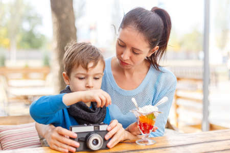 Young mother and her son in a cafe. The concept of family.の写真素材