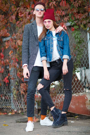 Guy with a girl on an autumn foliage backgroundの写真素材