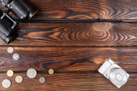 Binoculars on a wooden brown background. Close-up of binoculars. The concept of technology, leisure.