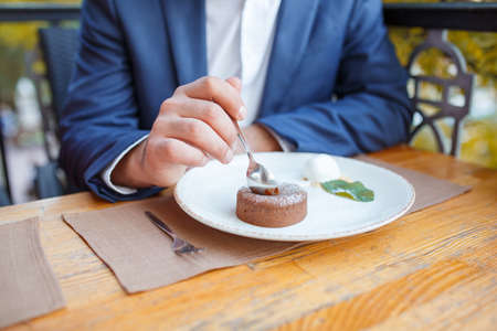 Handsome brunette man in the cafe on the natural background.の写真素材