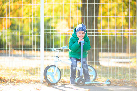 A boy plays in the autumn on the streetの写真素材