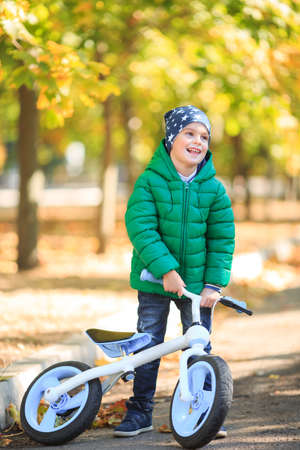 A boy plays in the autumn on the streetの写真素材