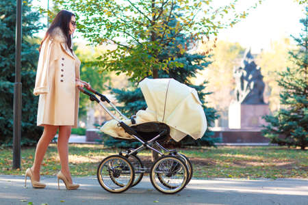 The dark-haired mother walks with a small child.の写真素材