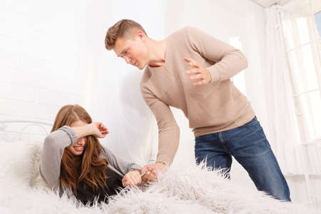 A guy swinging at a girl wants to hit her