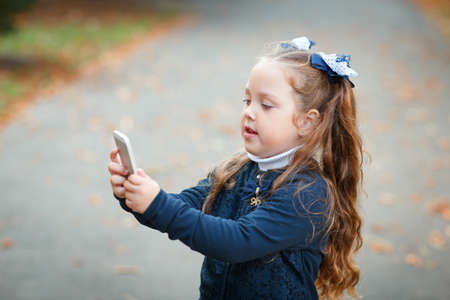 The girl is standing in the park in autumnの写真素材