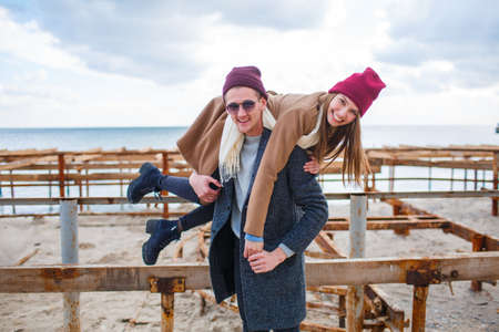 Cheerful young couple having fun and laughing together outdoors.