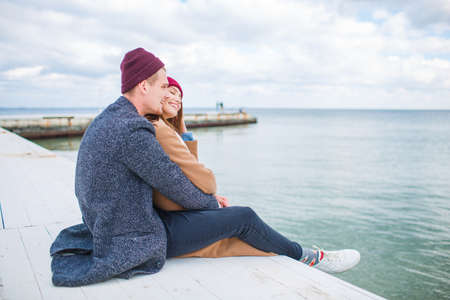 Cheerful young couple having fun and laughing together outdoors.の写真素材