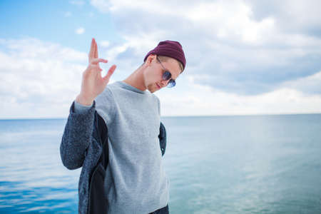 Handsome boy posing on the camera on the nature background.の写真素材