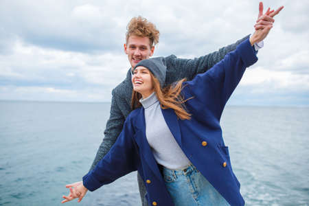 Cheerful young couple having fun and laughing together outdoors.