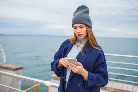Fashionably dressed woman having fun on the street.の写真素材