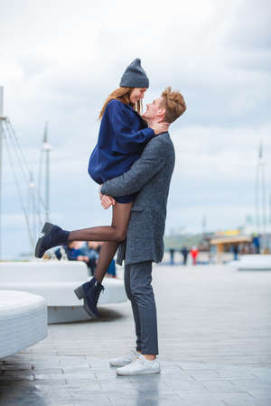Cute young couple having fun and laughing together outdoors.の写真素材