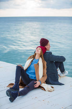 Cheerful young couple having fun and laughing together outdoors.の写真素材