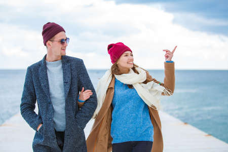 Cheerful young couple having fun and laughing together outdoors.