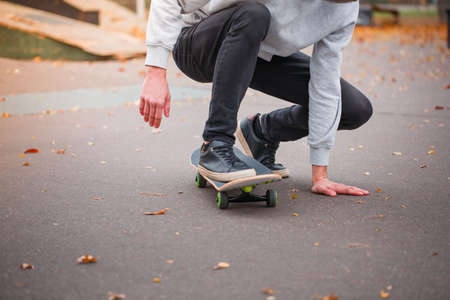 Young skate boy doing trick in skating park outdoors. Sport concept.の写真素材