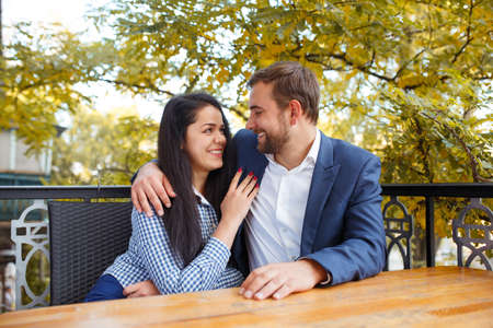 Young couple in a cafe. Outside.