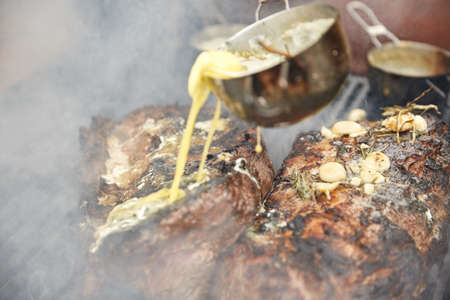 Steaks fry on a grid with seasonings and herbs on themの写真素材