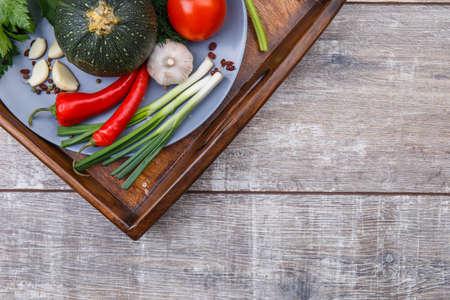 Close-up of freshly picked vegetables on a plate with a tray.の写真素材