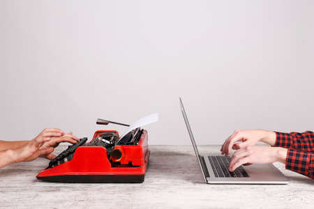 Old typewriter and laptop on table. Concept of technology progress