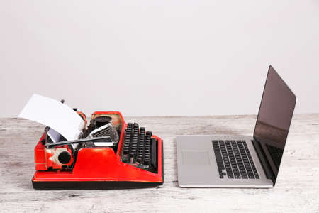 Old typewriter and laptop on table. Concept of technology progressの写真素材