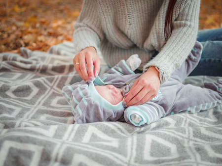 Young mother with her little boy, in the autumn park