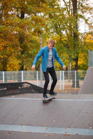 A young skateboarder practicing in a skate park.の写真素材