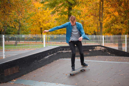 A young skateboarder practicing in a skate park.の写真素材