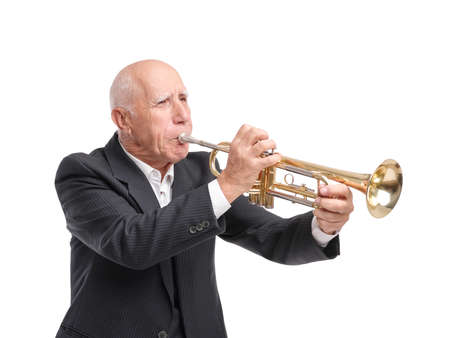 Grandpa playing on trumpet on white isolated backgroundの写真素材