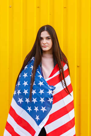 Sexy girl girl in a black jacket covered in USA flagの写真素材