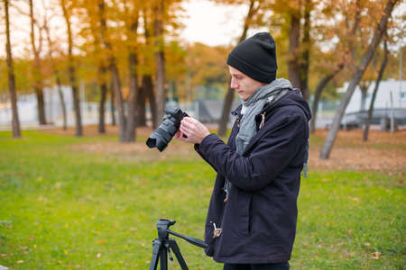 The videoblogger adjusts look his cameraの写真素材