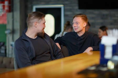 Group of two male friends resting in the bar.の写真素材