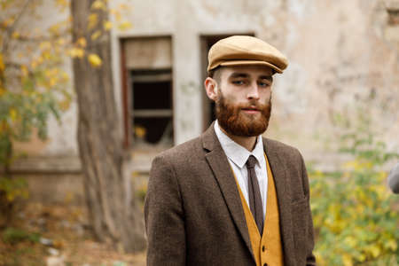 Gangster with a beard and hat near an abandoned building. Retro. Outdoors.の写真素材