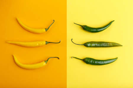 Yellow and green pepper on orange and yellow backgroundの写真素材