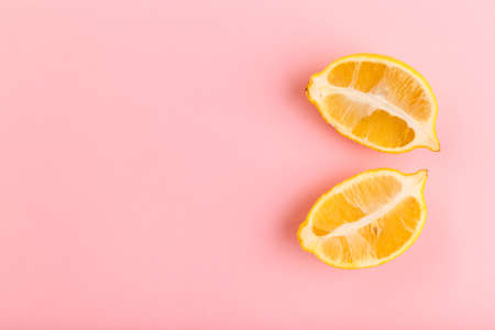 Two halves of juicy lemon on a pink backgroundの写真素材