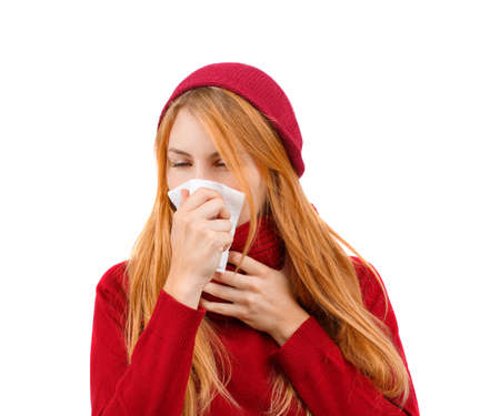 Young girl in red is going to sneeze on white isolated backgroundの写真素材