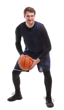 Portrait of a professional basketball player in a rack with a ball. Isolated over white backgroundの写真素材