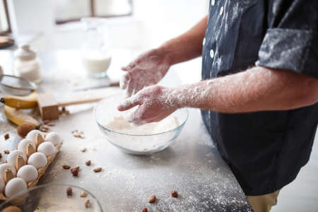 Close-up of a mans hand in flour. The concept of cooking in the kitchenの写真素材