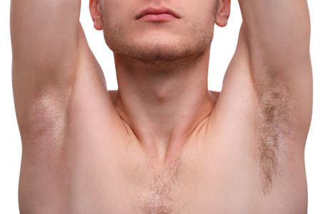 Close-up of a man raising his hands and showing his armpits, one armpit shaved, the second is not,...