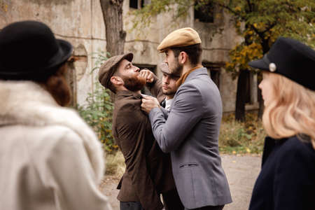 Close-up of a fight, a gangster beats a man, a gangster attack, Retro. On open air.の写真素材