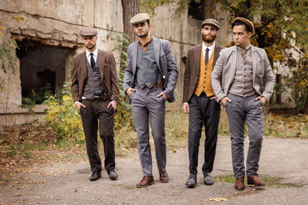 A group of dangerous retro gangsters are walking in the park.の写真素材