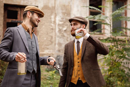 Gangsters on the background of the old abandoned building talking. Retro concept.の写真素材