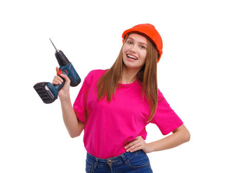 Happy girl holding drill on white isolated backgroundの写真素材