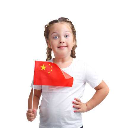 Little girl with flag in hand on white isolated backgroundの写真素材