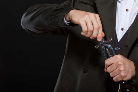 Hands open with a corkscrew bottle on a black backgroundの写真素材
