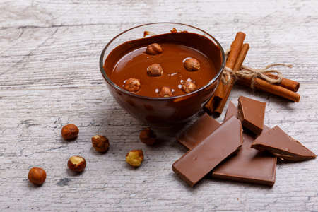 Chopped milk chocolate with hazelnuts on the tableの写真素材