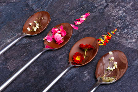 Spoons with frozen chocolate lie in a rowの写真素材