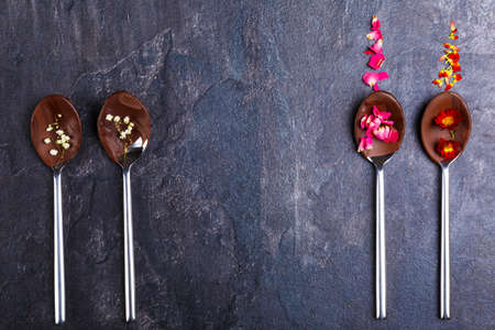 Two spoons on the right and two on the left with frozen chocolateの写真素材