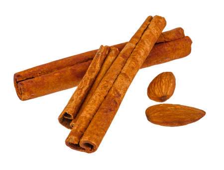 Cinnamon sticks and almonds on white isolated background